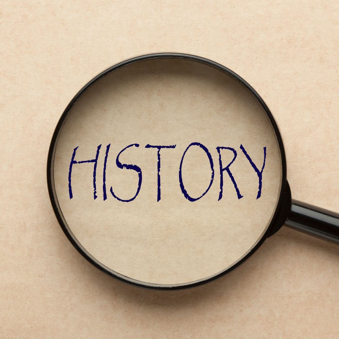 Vergrootglas met daaronder het woord 'history' oftewel geschiedenis